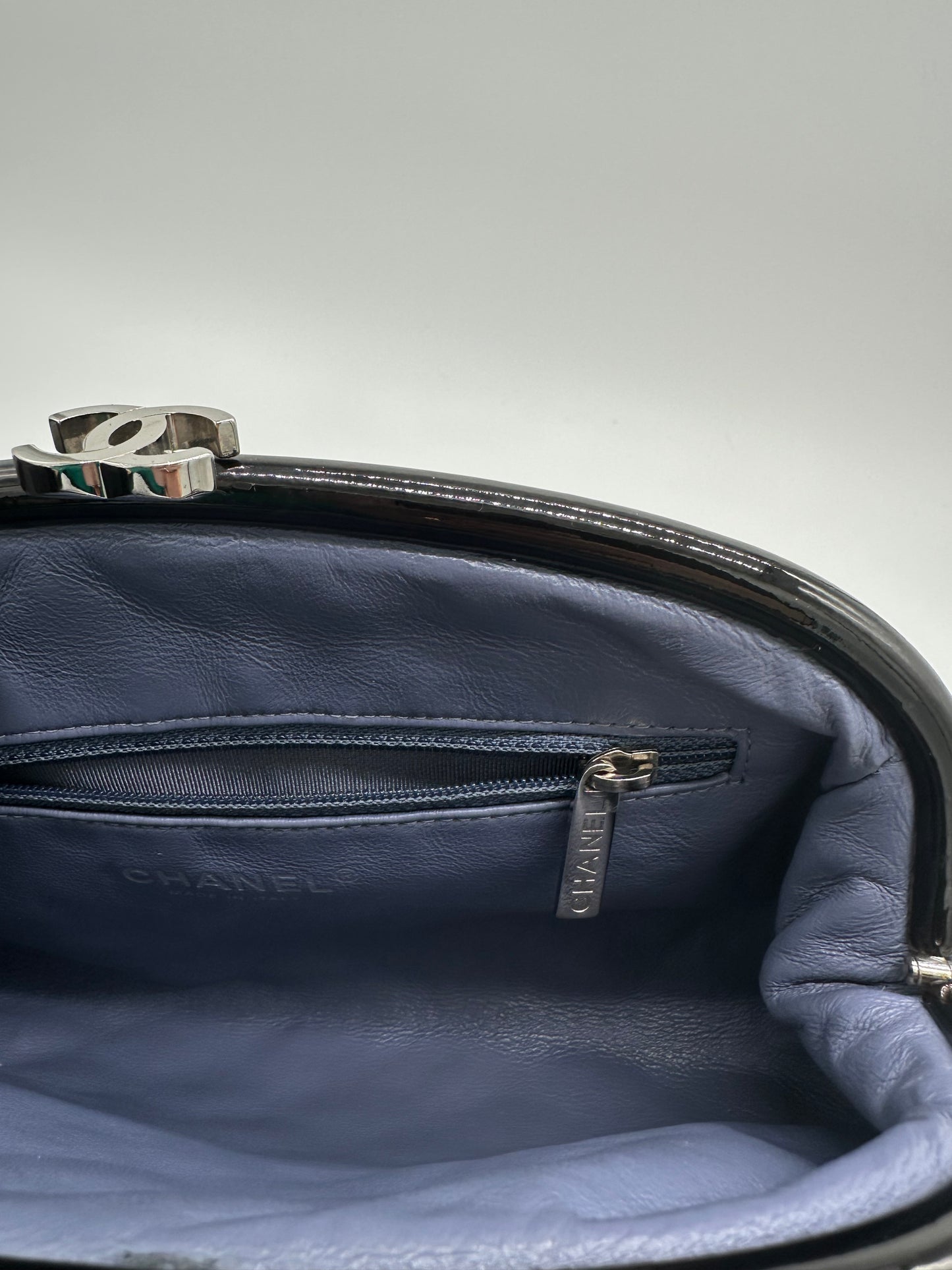 Luxury Soluciens Pre-owned Chanel black patent leather quilted timeless clutch with silver toned hardware